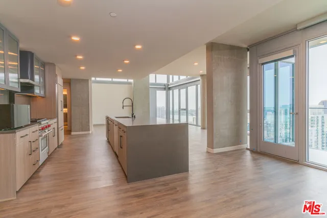 a kitchen with granite countertop a stove and a wooden floor