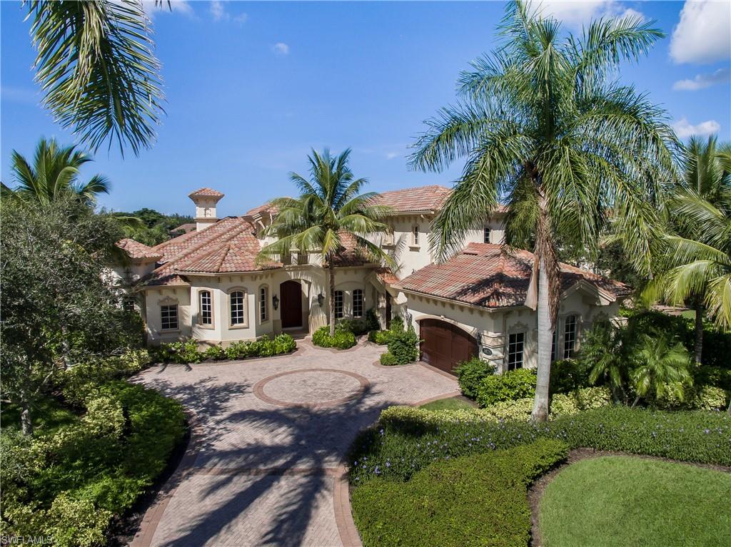 3875 Isla Del Sol Way Naples, FL 34114 - Photo 2 of 24 a front view of a house with a garden