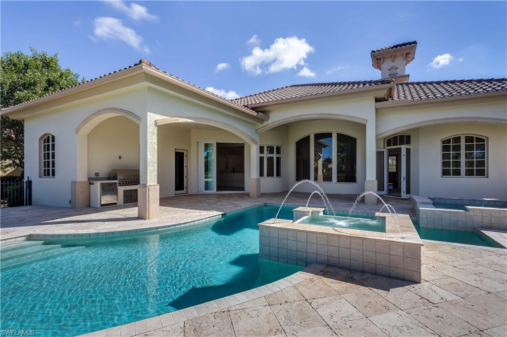 3875 Isla Del Sol Way Naples, FL 34114 - Photo 23 of 24 a view of a house with backyard porch and patio