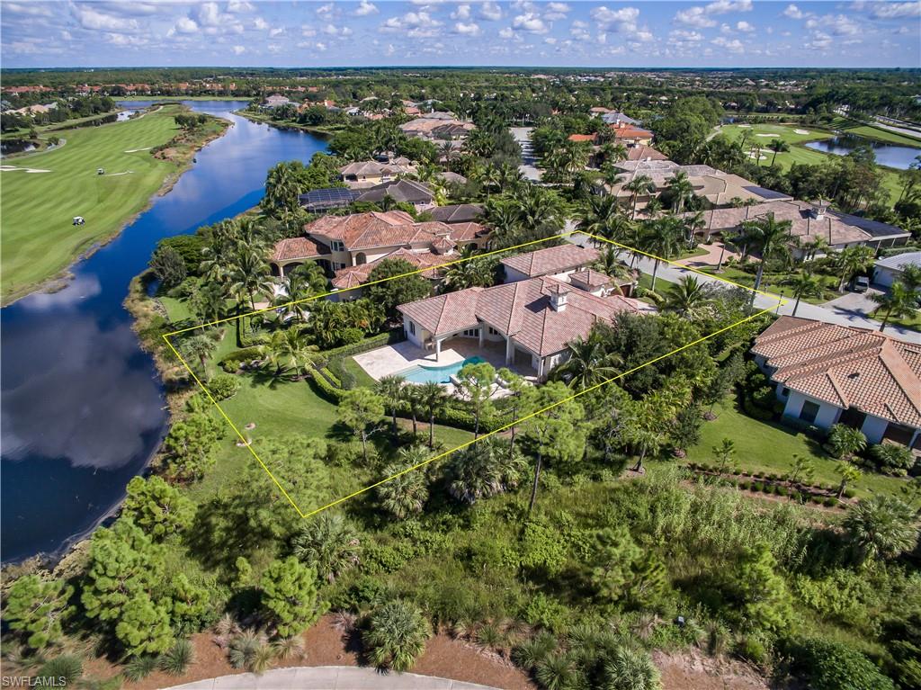 3875 Isla Del Sol Way Naples, FL 34114 - Photo 8 of 24 an aerial view of a houses with a lush green hillside