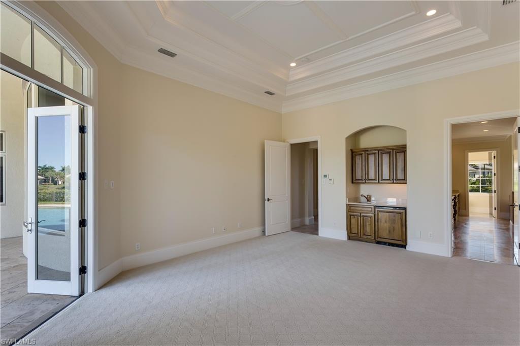 3875 Isla Del Sol Way Naples, FL 34114 - Photo 10 of 24 wooden floor in an empty room with a window