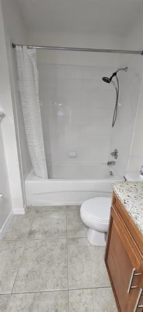 a bathroom with a granite countertop bathtub and toilet