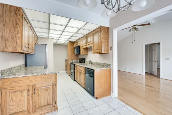 a kitchen with stainless steel appliances granite countertop a sink and a stove