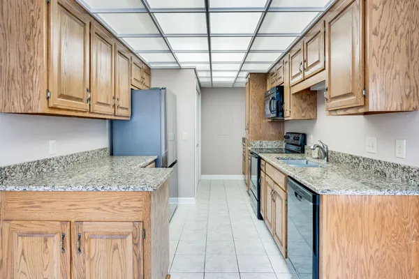 a kitchen with stainless steel appliances granite countertop a sink stove and cabinets