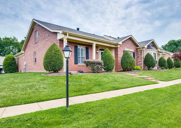 a front view of house with yard and green space