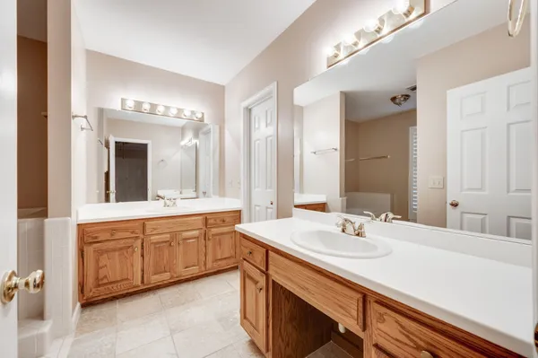 a bathroom with a sink double vanity granite and a mirror