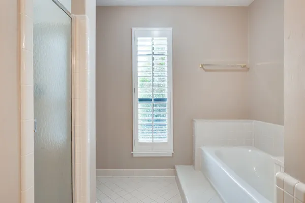 a bathroom with bathtub and window