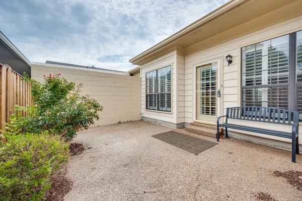 a view of backyard with large windows and plants