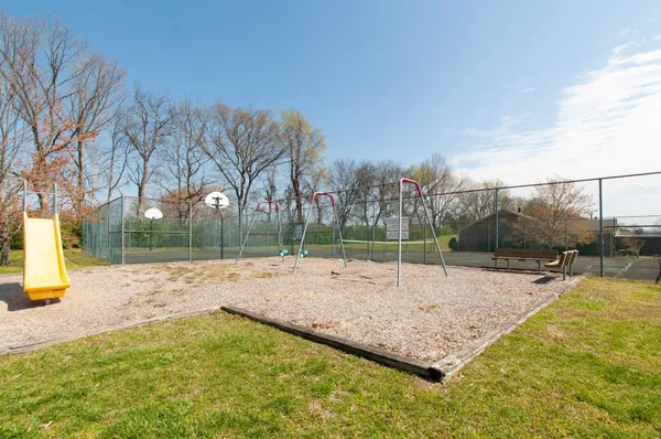 a swimming pool with some trees in the background
