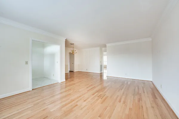 a view of an empty room and wooden floor