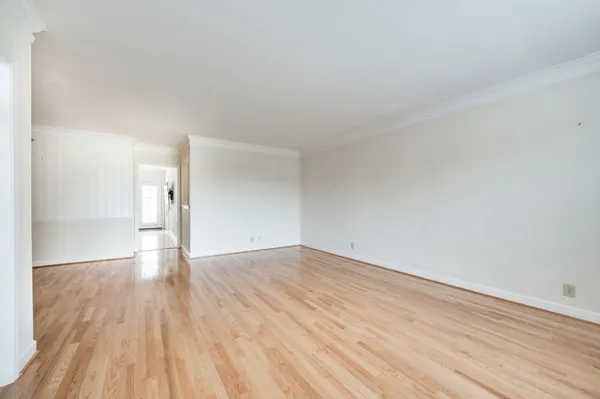 a view of an empty room and wooden floor
