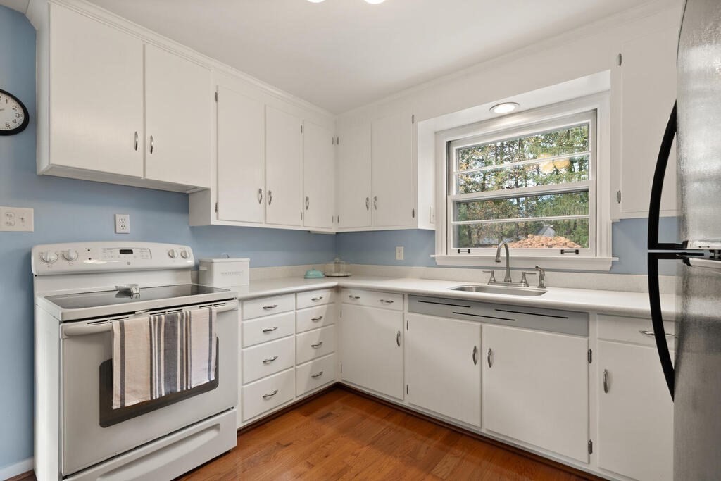 28 Montview Road Chelmsford, MA 01824 - Photo 13 of 38 a kitchen with cabinets appliances a sink and a window