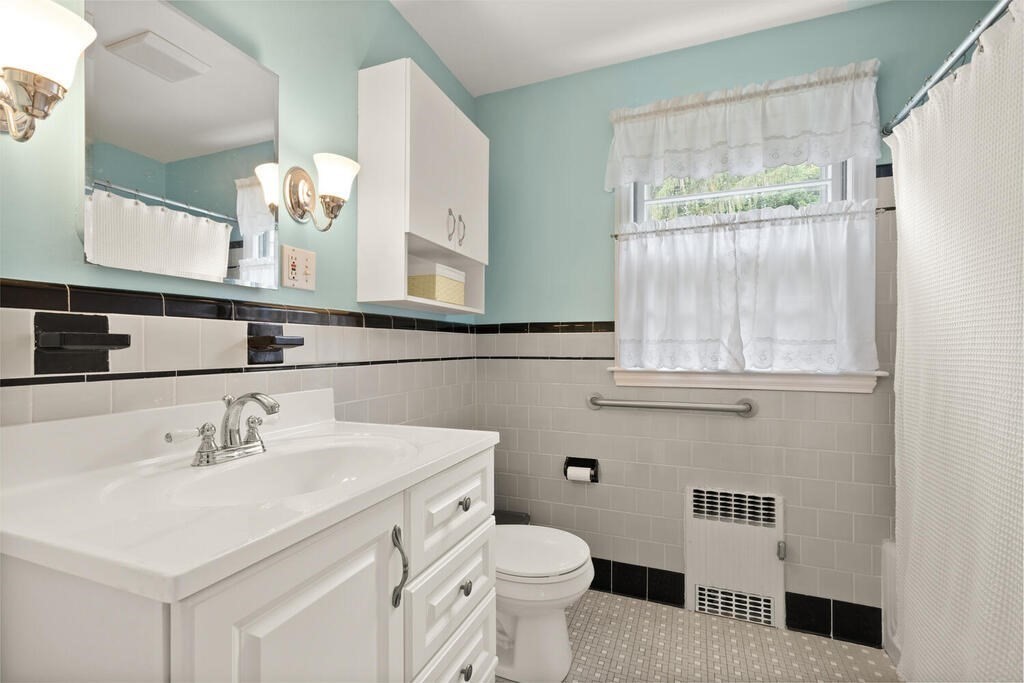 28 Montview Road Chelmsford, MA 01824 - Photo 17 of 38 a bathroom with a sink a toilet and a mirror