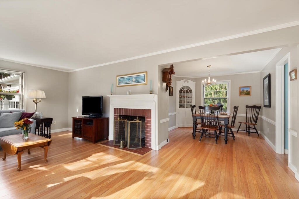 28 Montview Road Chelmsford, MA 01824 - Photo 9 of 38 a living room with furniture a fireplace and a flat screen tv