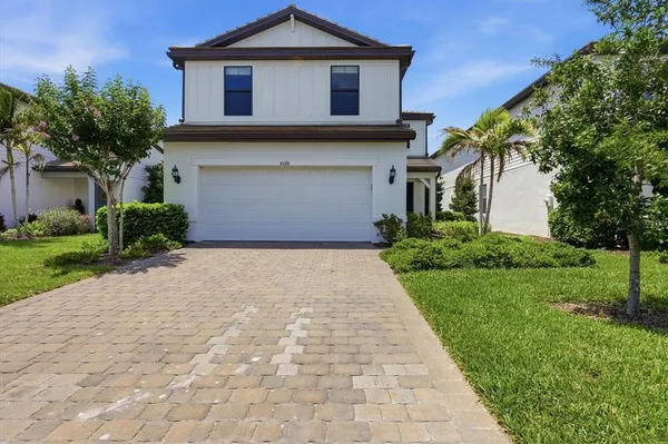 a front view of a house with a yard and garage