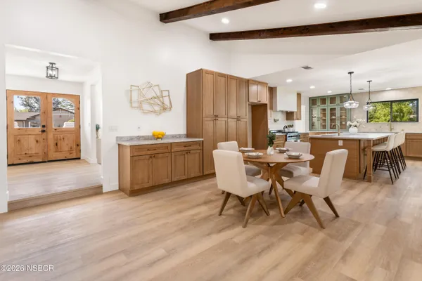 a view of a dining room with furniture and chandelier