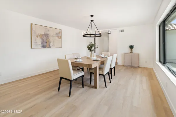 a view of a dining room with furniture window and wooden floor