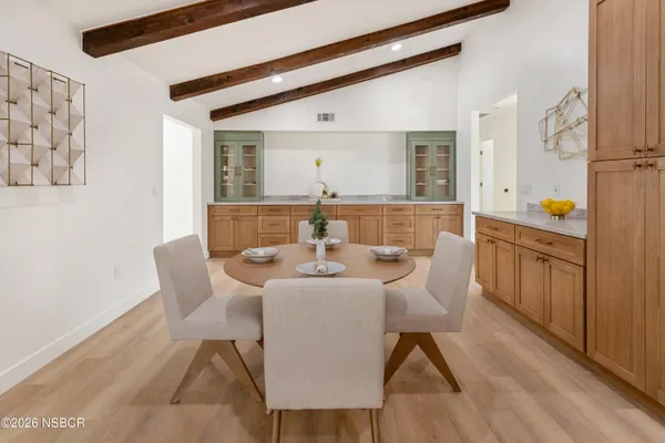 a view of a dining room with furniture and wooden floor