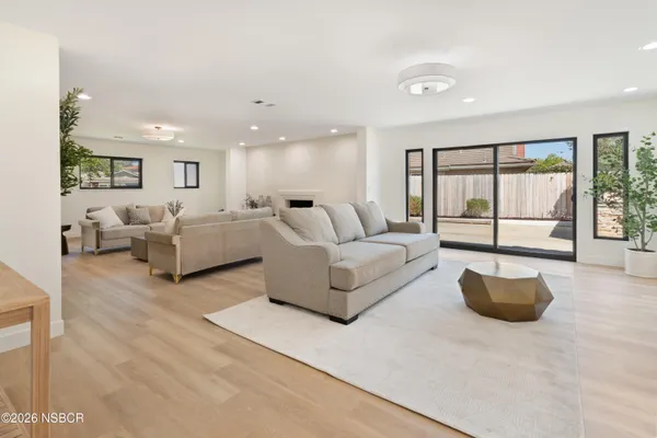a living room with furniture and large windows