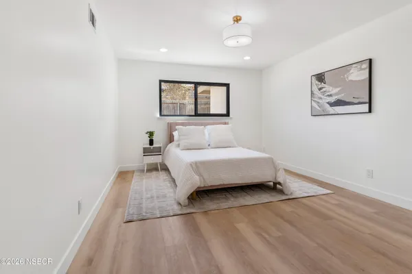 a spacious bedroom with a bed and a window