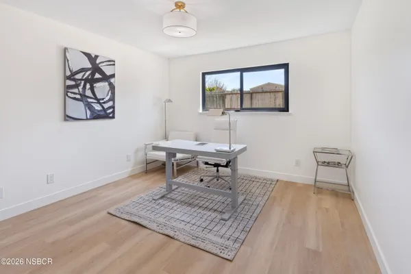 a living room with a table and a rug