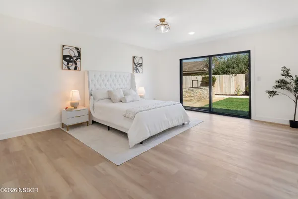 a spacious bedroom with a bed and a large window