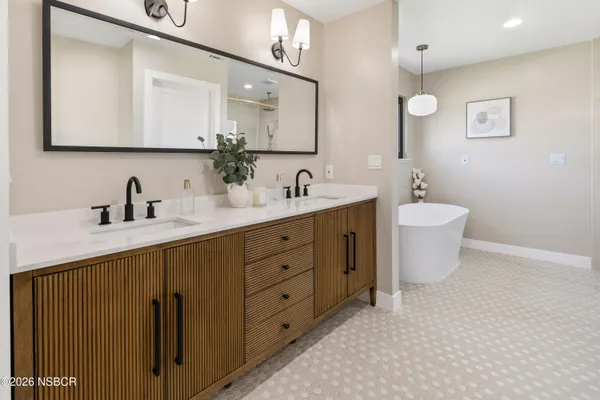 a bathroom with a double vanity sink mirror and toilet