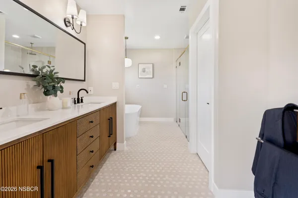 a bathroom with a double vanity sink mirror and toilet