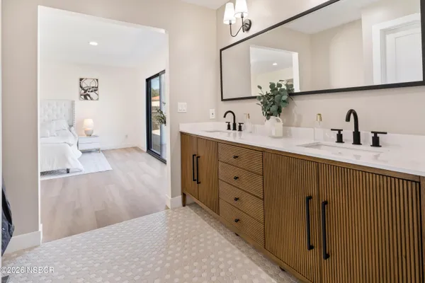 a bathroom with a double vanity sink and mirror