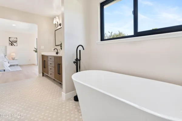 a bathroom with a tub sink and view