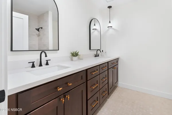 a bathroom with a double vanity sink and a mirror