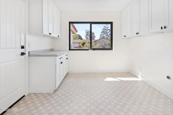 a view of kitchen with window and cabinets