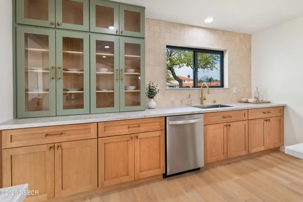 a kitchen with stainless steel appliances granite countertop a sink and cabinets