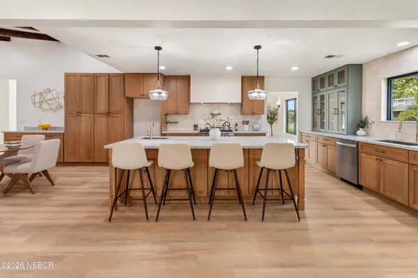a large kitchen with a table and chairs