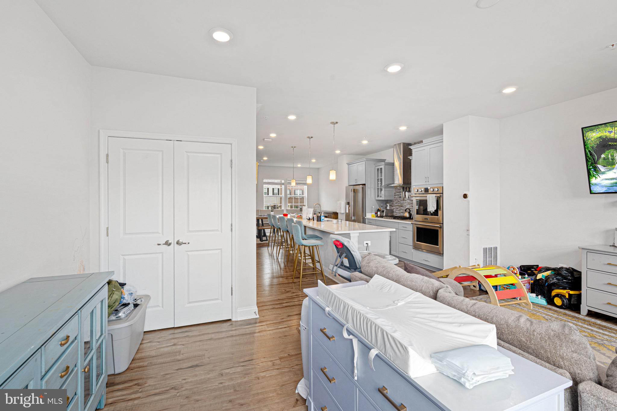 7583 Marston Way Hanover, MD 21076 - Photo 11 of 36 a kitchen that has a lot of cabinets a sink and wooden floor
