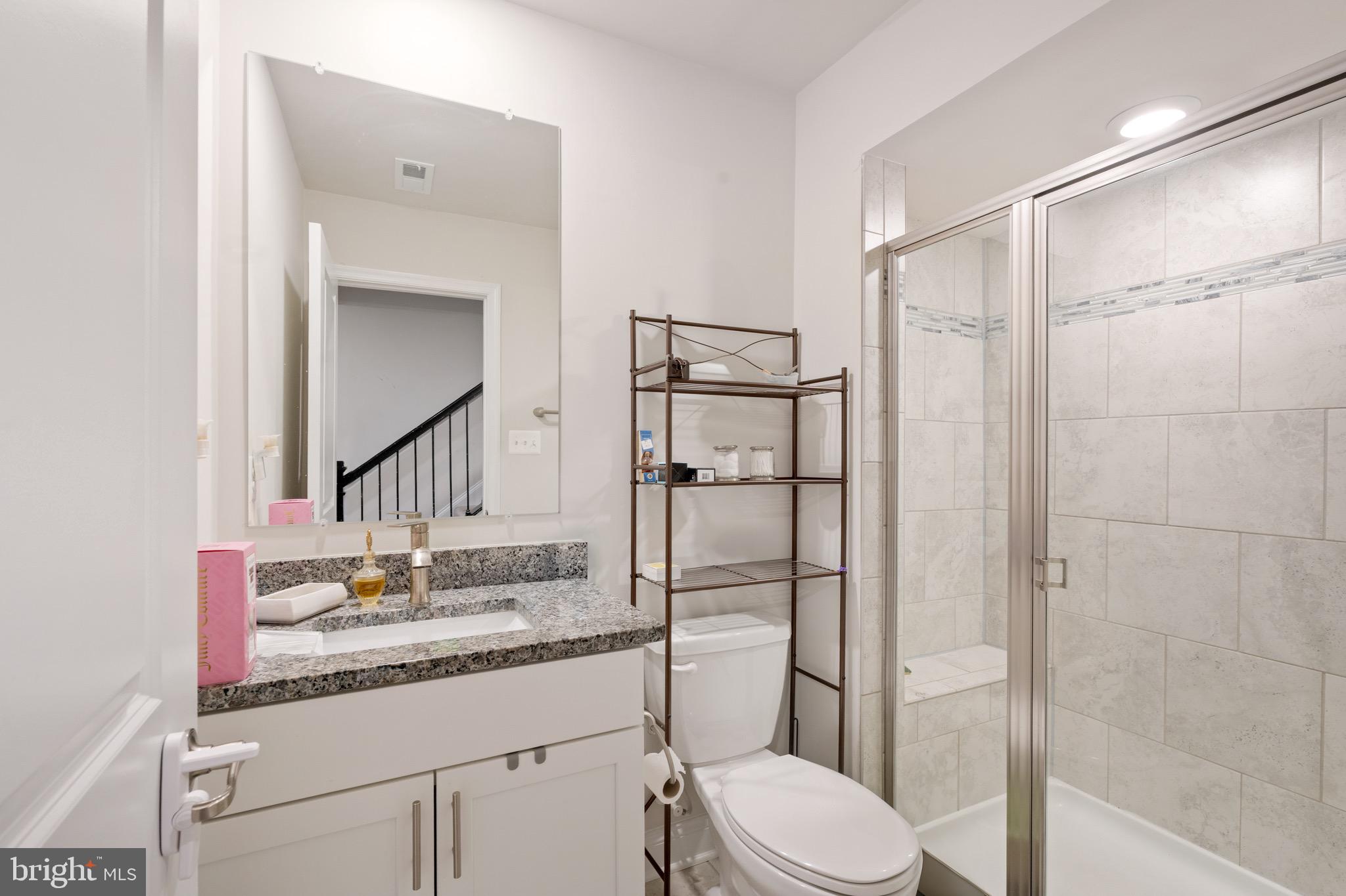 7583 Marston Way Hanover, MD 21076 - Photo 16 of 36 a bathroom with a granite countertop sink toilet and shower