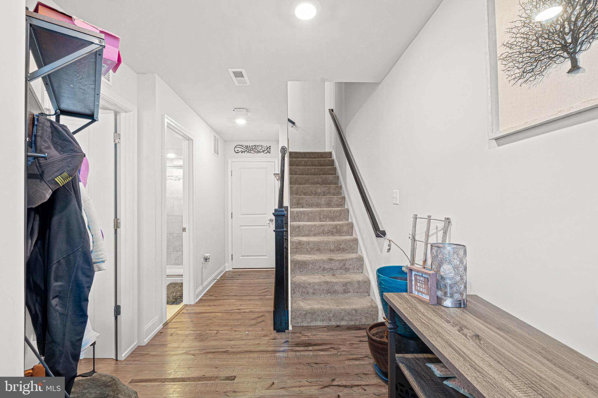 7583 Marston Way Hanover, MD 21076 - Photo 19 of 36 a view of a hallway with wooden floor and staircase
