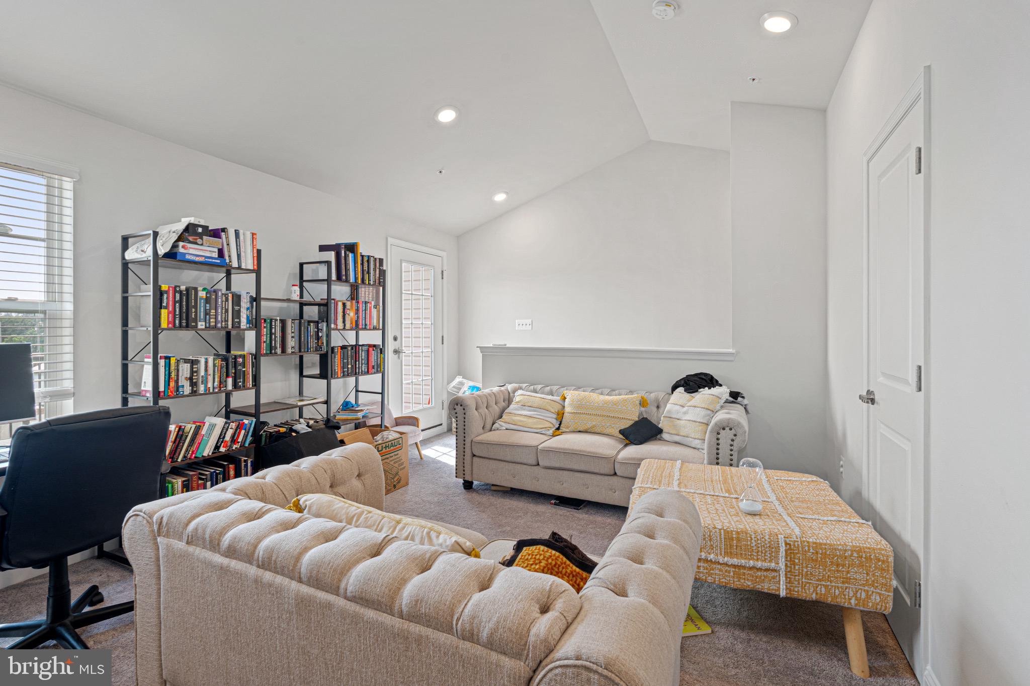 7583 Marston Way Hanover, MD 21076 - Photo 29 of 36 a living room with furniture and a book shelf