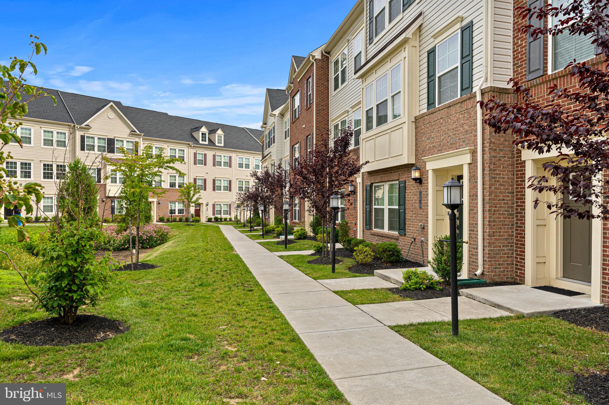 7583 Marston Way Hanover, MD 21076 - Photo 3 of 36 a view of a brick building next to a yard