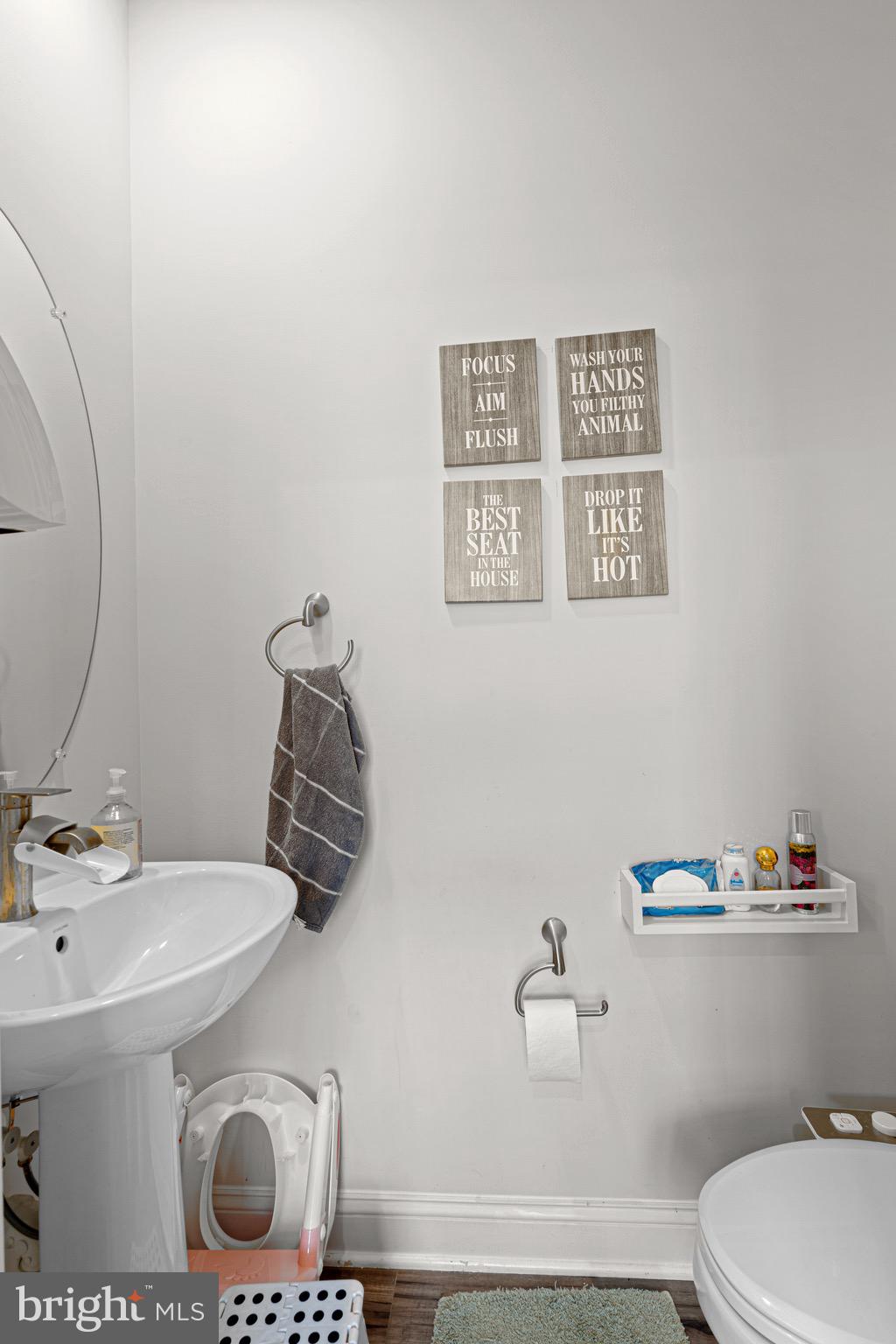 7583 Marston Way Hanover, MD 21076 - Photo 31 of 36 a bathroom with a toilet sink and mirror