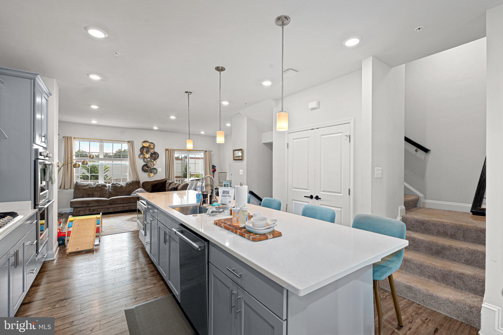 7583 Marston Way Hanover, MD 21076 - Photo 7 of 36 a large kitchen with lots of counter space a sink appliances and living room view
