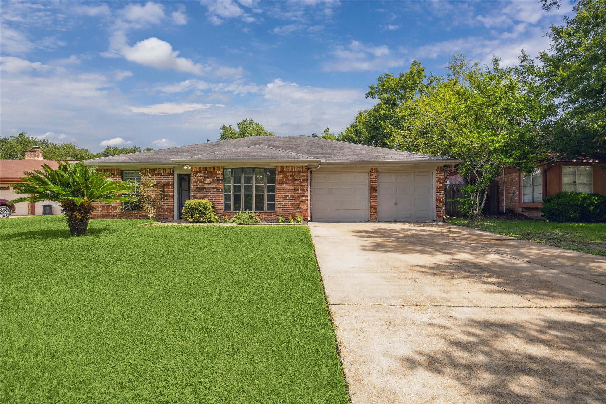 a front view of house with yard and green space
