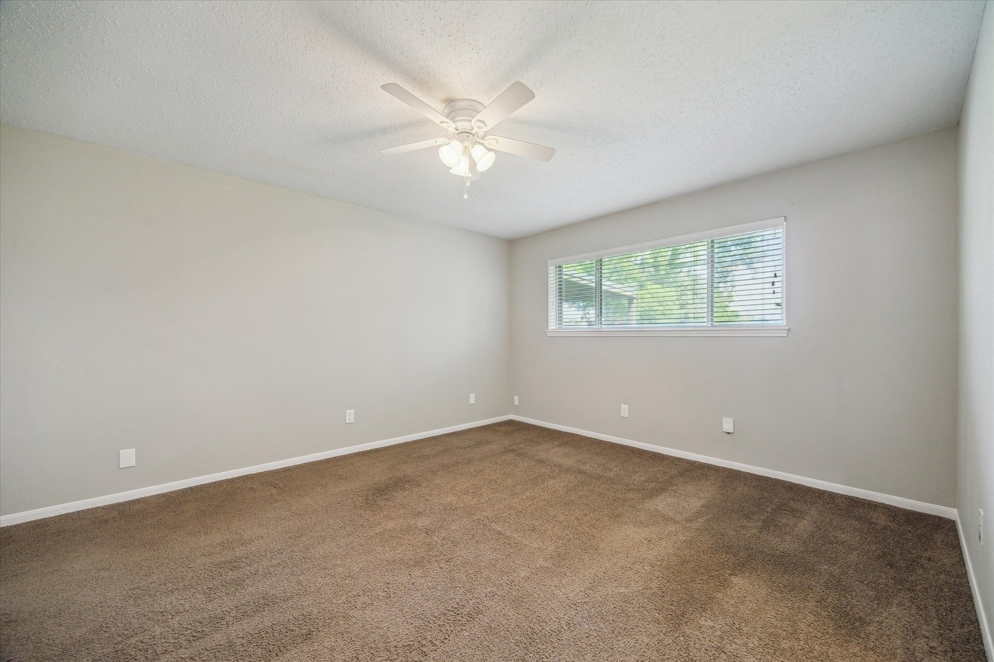 2717 Parrott Avenue Rosenberg, TX 77471 - Photo 12 of 20 an empty room with windows and chandelier fan