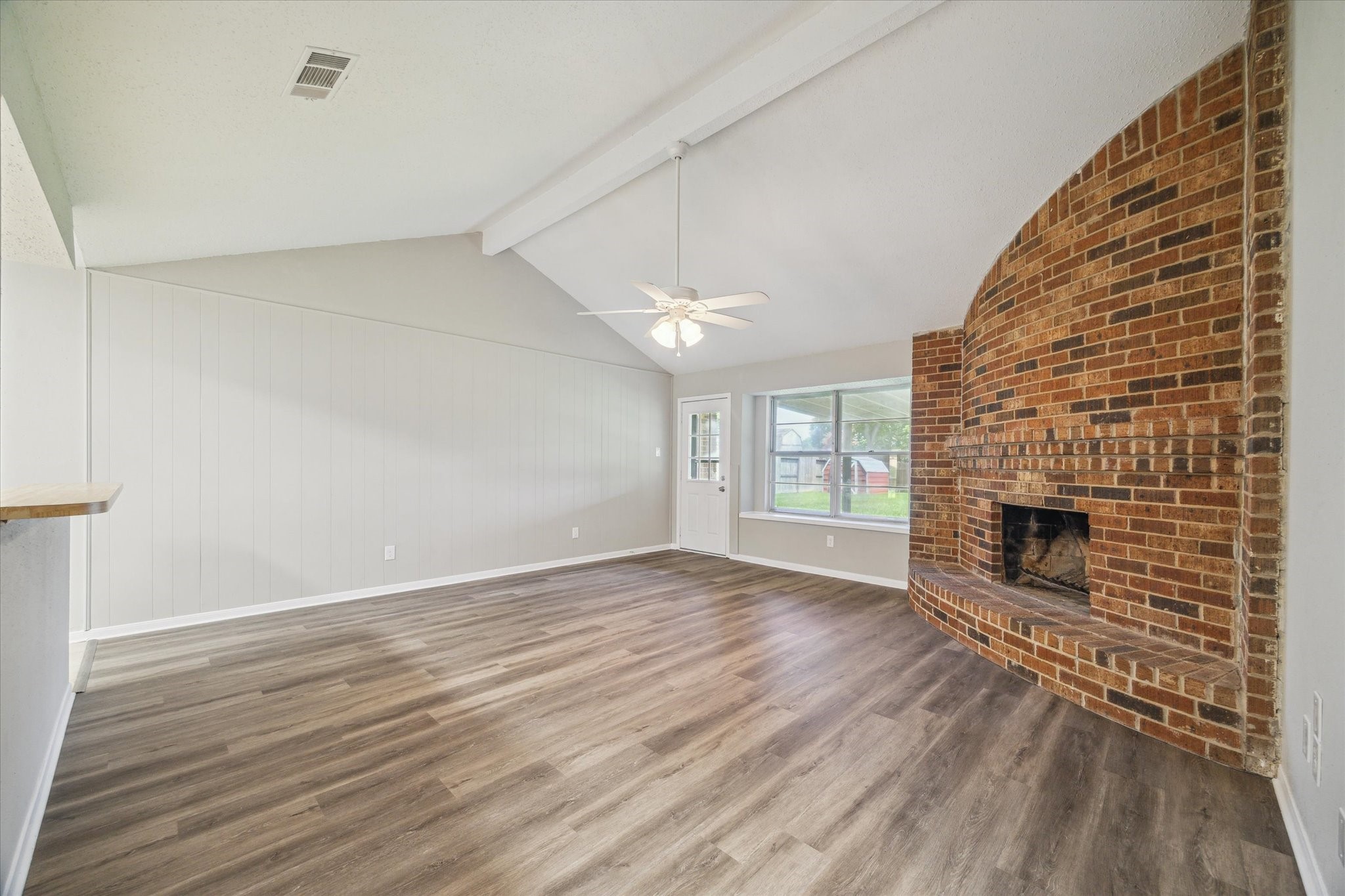 2717 Parrott Avenue Rosenberg, TX 77471 - Photo 4 of 20 a view of a livingroom with wooden floor a fireplace and windows