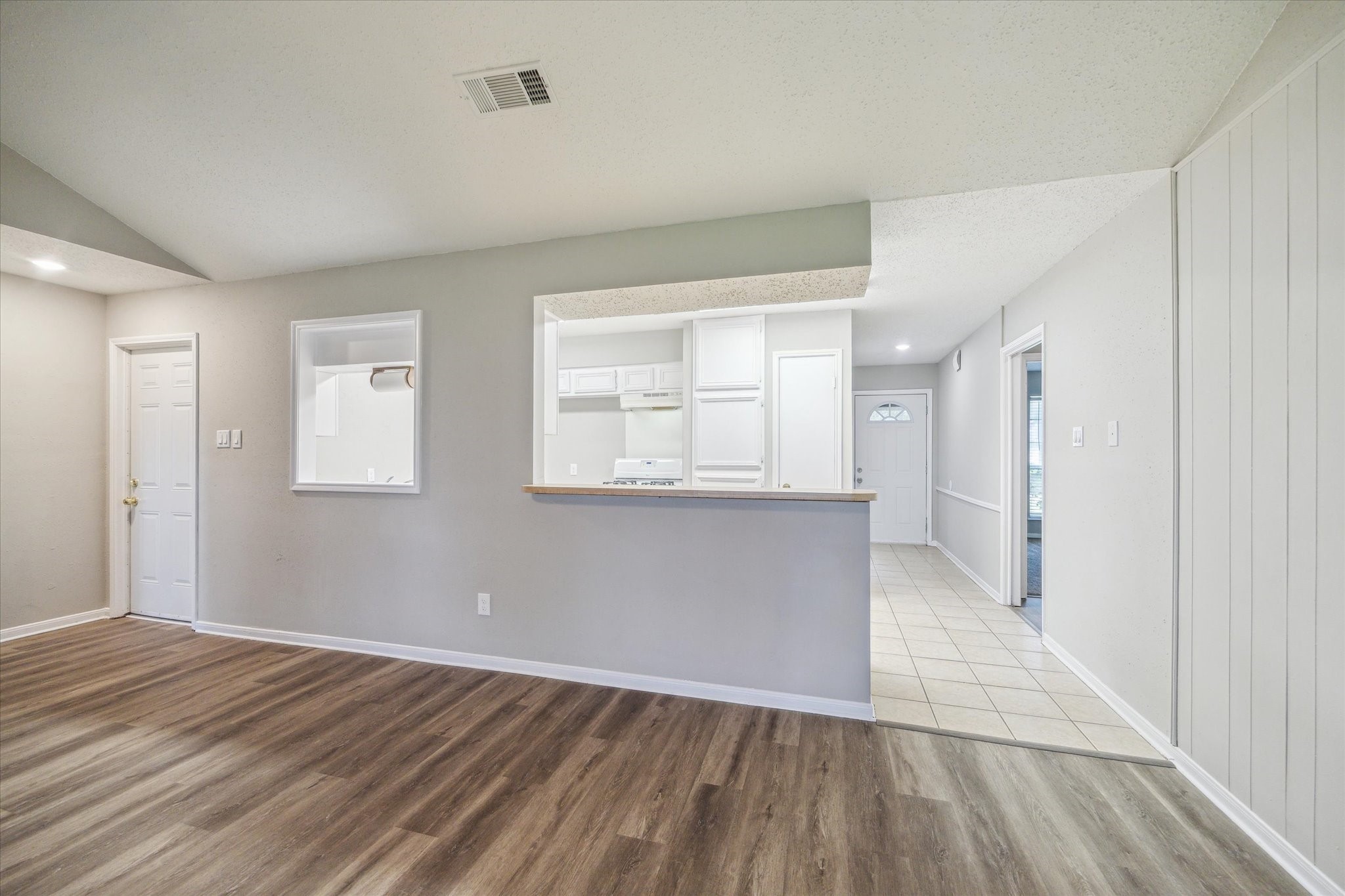 2717 Parrott Avenue Rosenberg, TX 77471 - Photo 5 of 20 a view of an empty room with wooden floor and a window