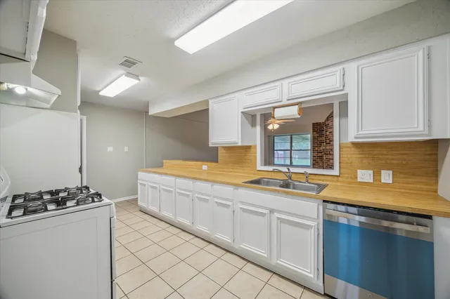 a spacious bathroom with a granite countertop sink and a mirror