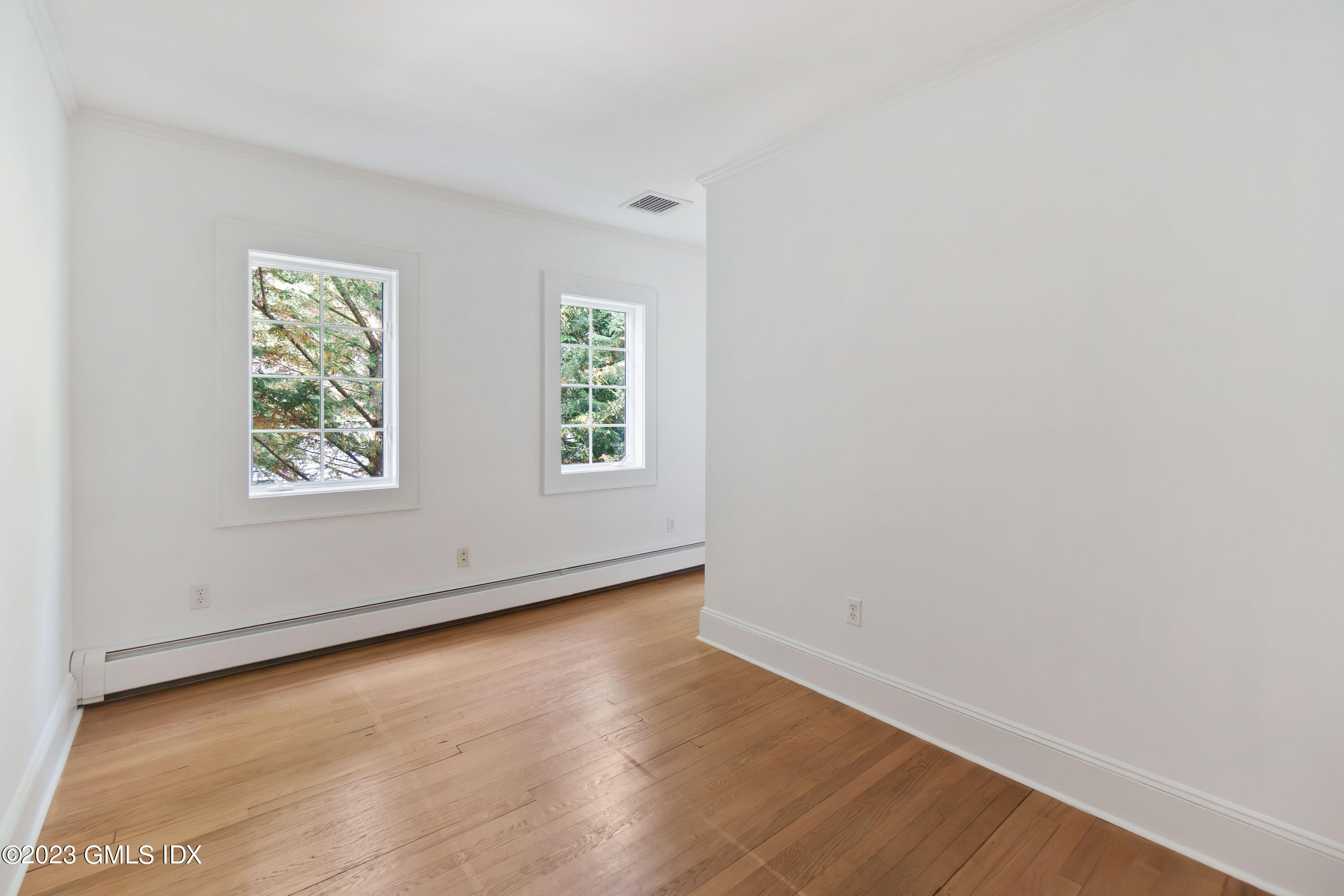 20 Center Road Old Greenwich, CT 06870 - Photo 21 of 35 an empty room with wooden floor and windows