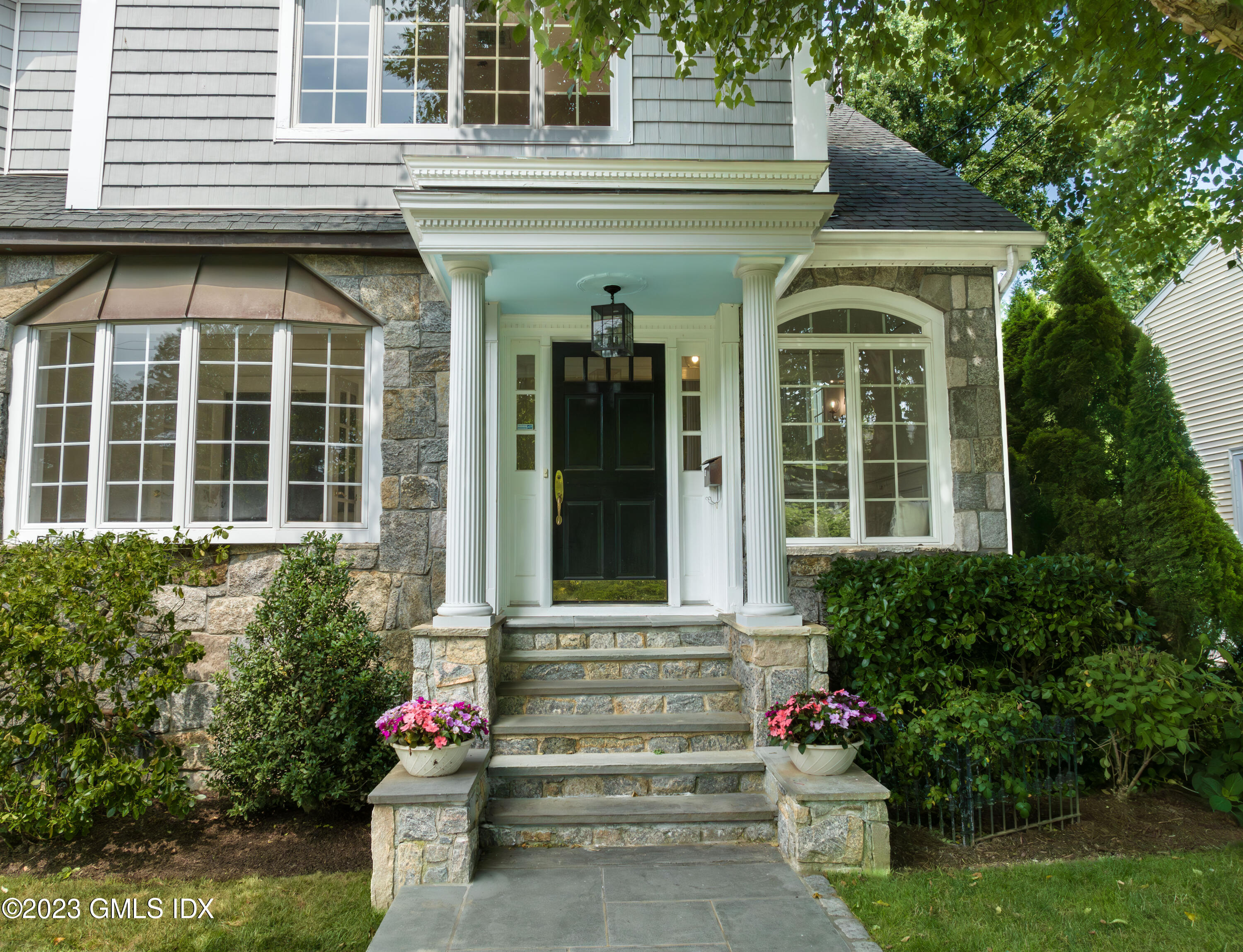 20 Center Road Old Greenwich, CT 06870 - Photo 3 of 35 a front view of a house with a lots of flower plants