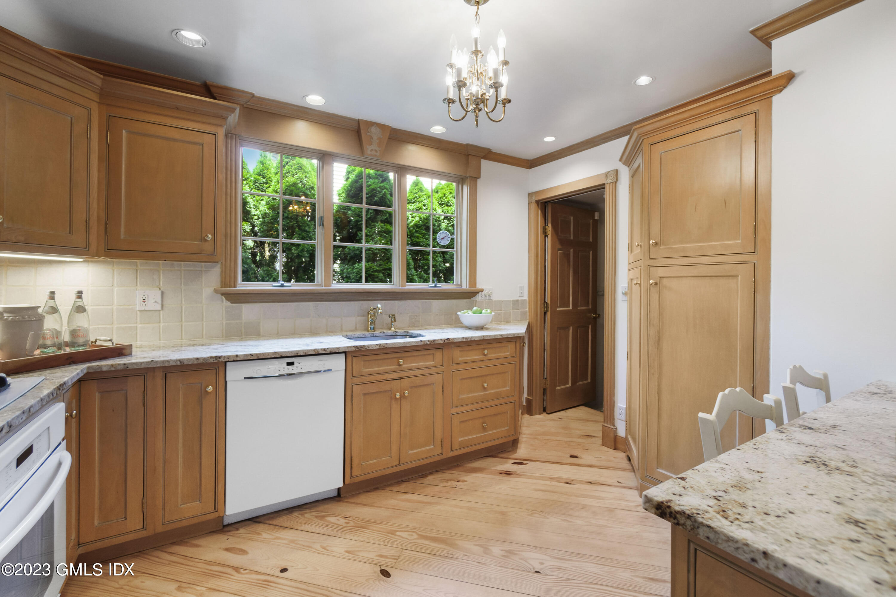 20 Center Road Old Greenwich, CT 06870 - Photo 10 of 35 a large kitchen with kitchen island granite countertop a sink and cabinets