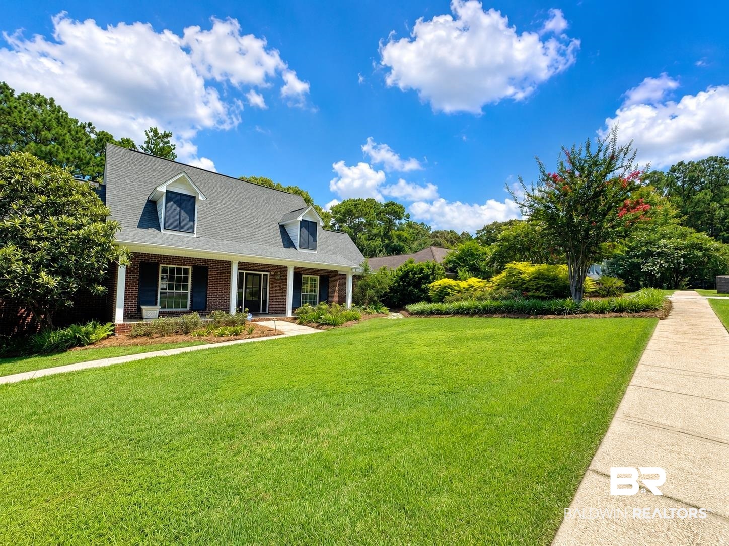 103 Raphael Semmes Drive East Daphne, AL 36527 - Photo 1 of 1 Brick exterior featuring a covered porch with white columns